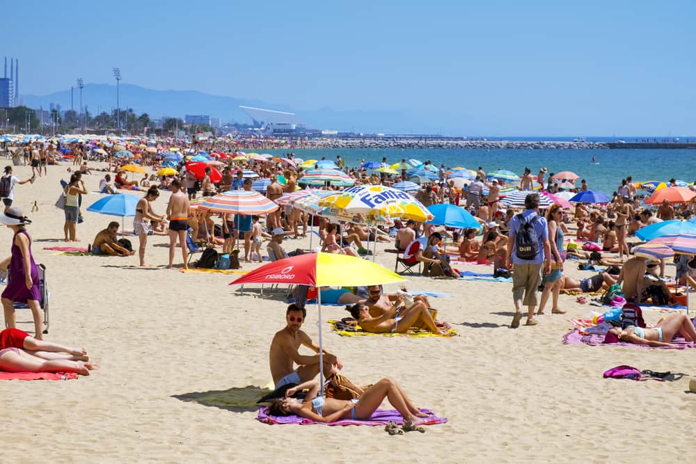 people at Platja del Bogatell beach, in Barcelona, Spain